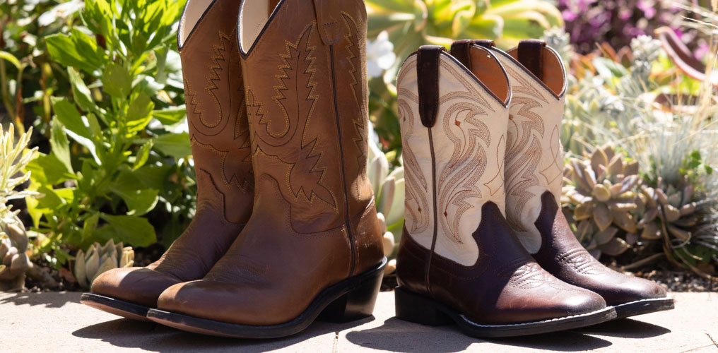 Two kids boots and jeans with graphic.