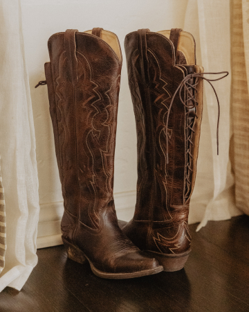 A tall brown pair of boots.