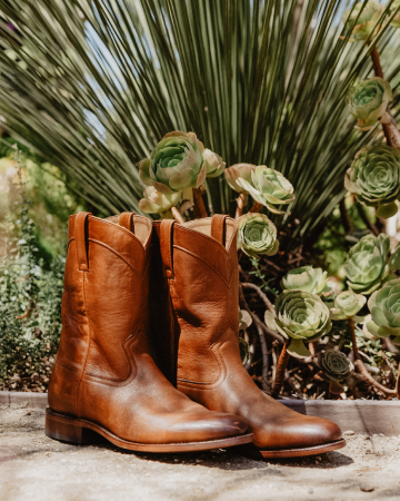 A pair of boots with greenery