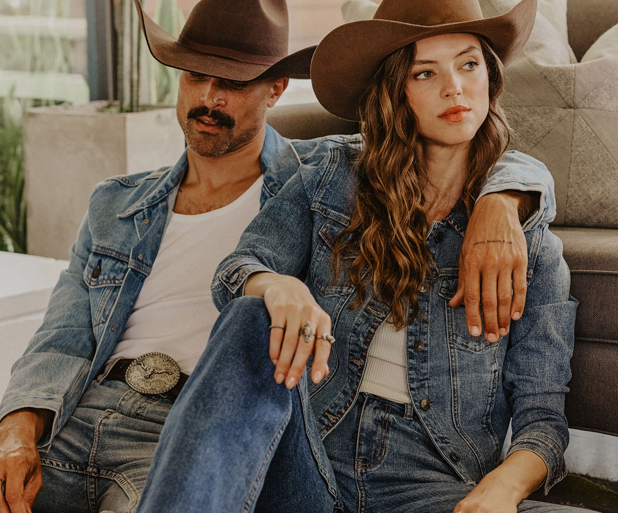 A man and woman in denim outfits.
