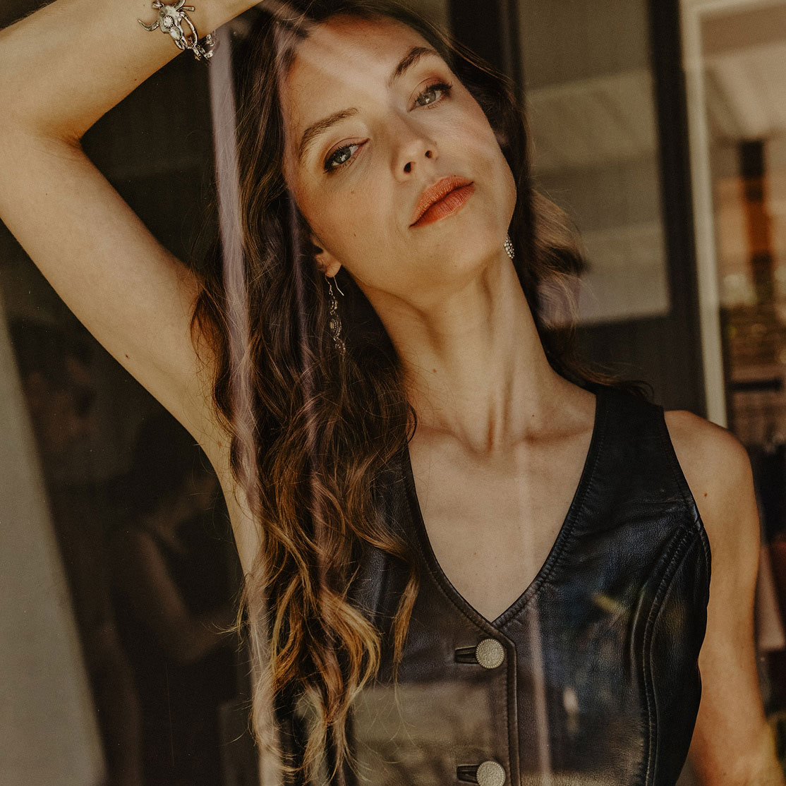 woman wearing leather vest.