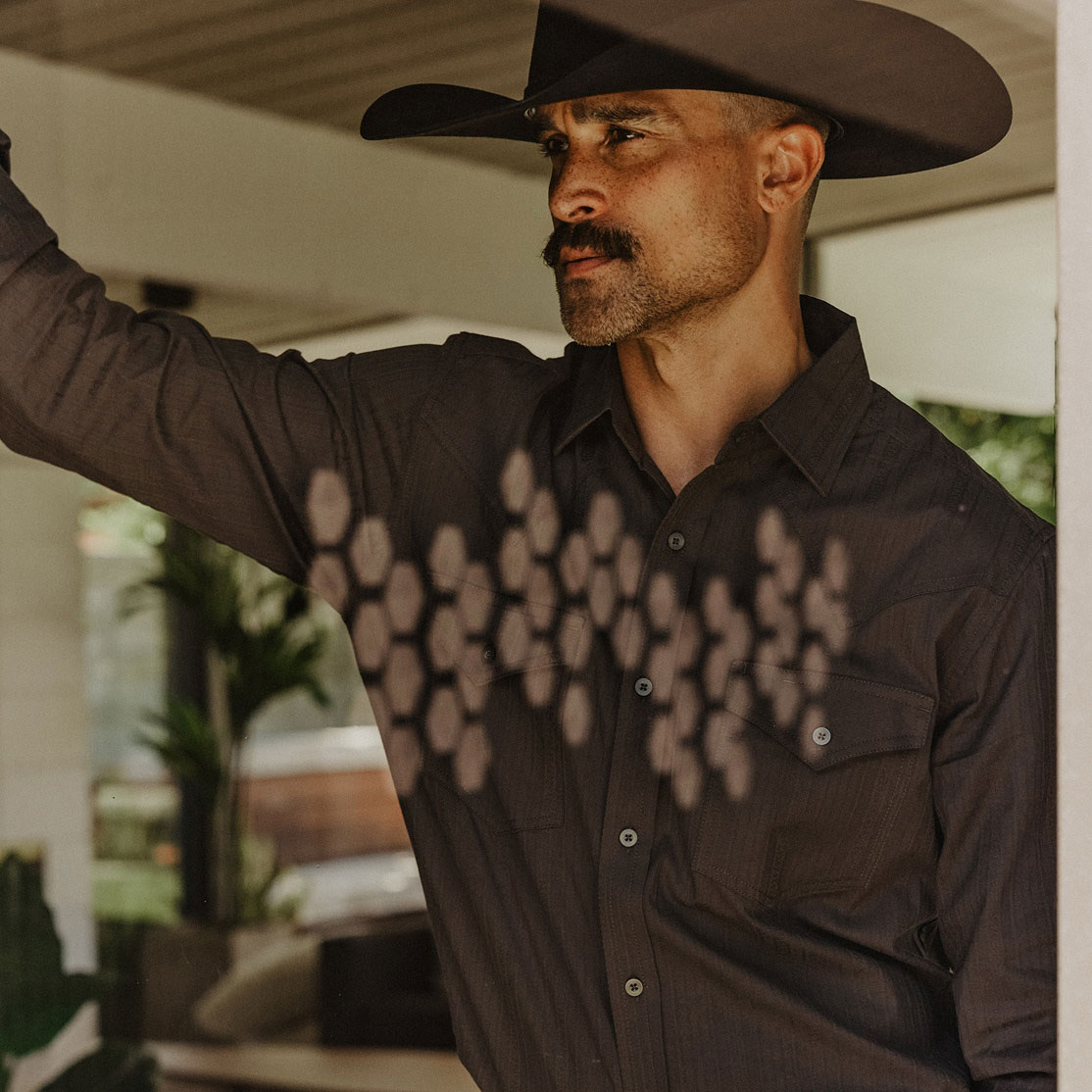 Man with cowboy hat and western shirt.