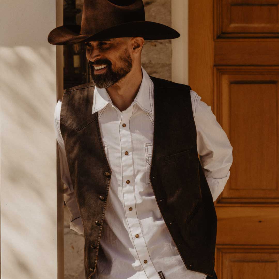 Man with cowboy hat and western shirt.
