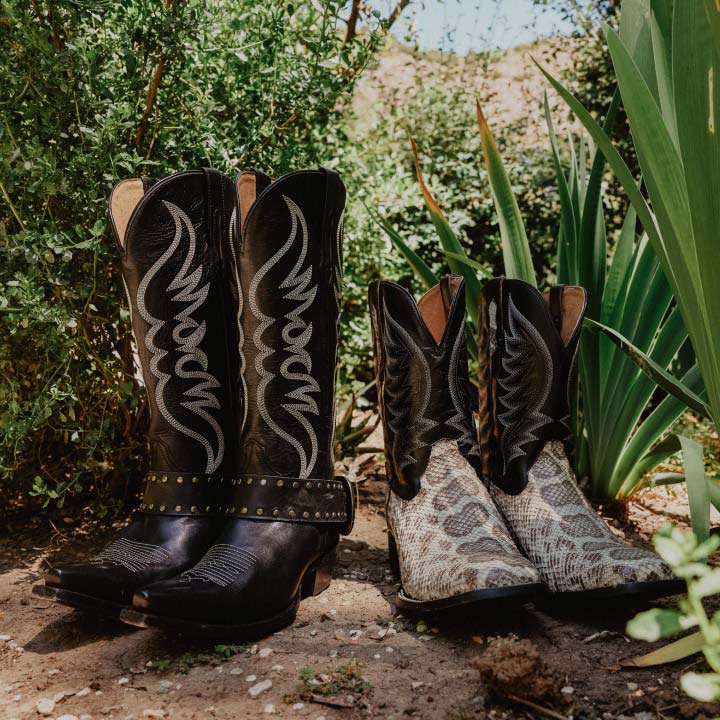  mens and womens black boots on dirt