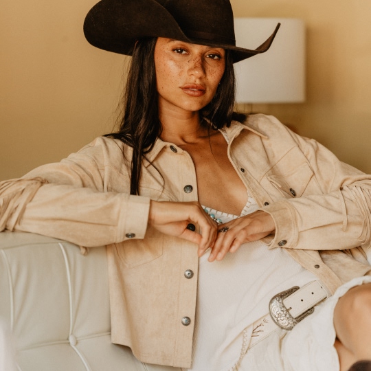 woman wearing white with beige jacket