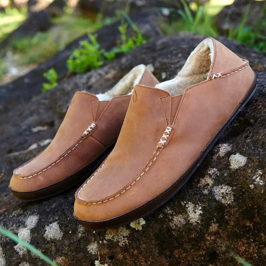 olukai slip-on with greenery background.