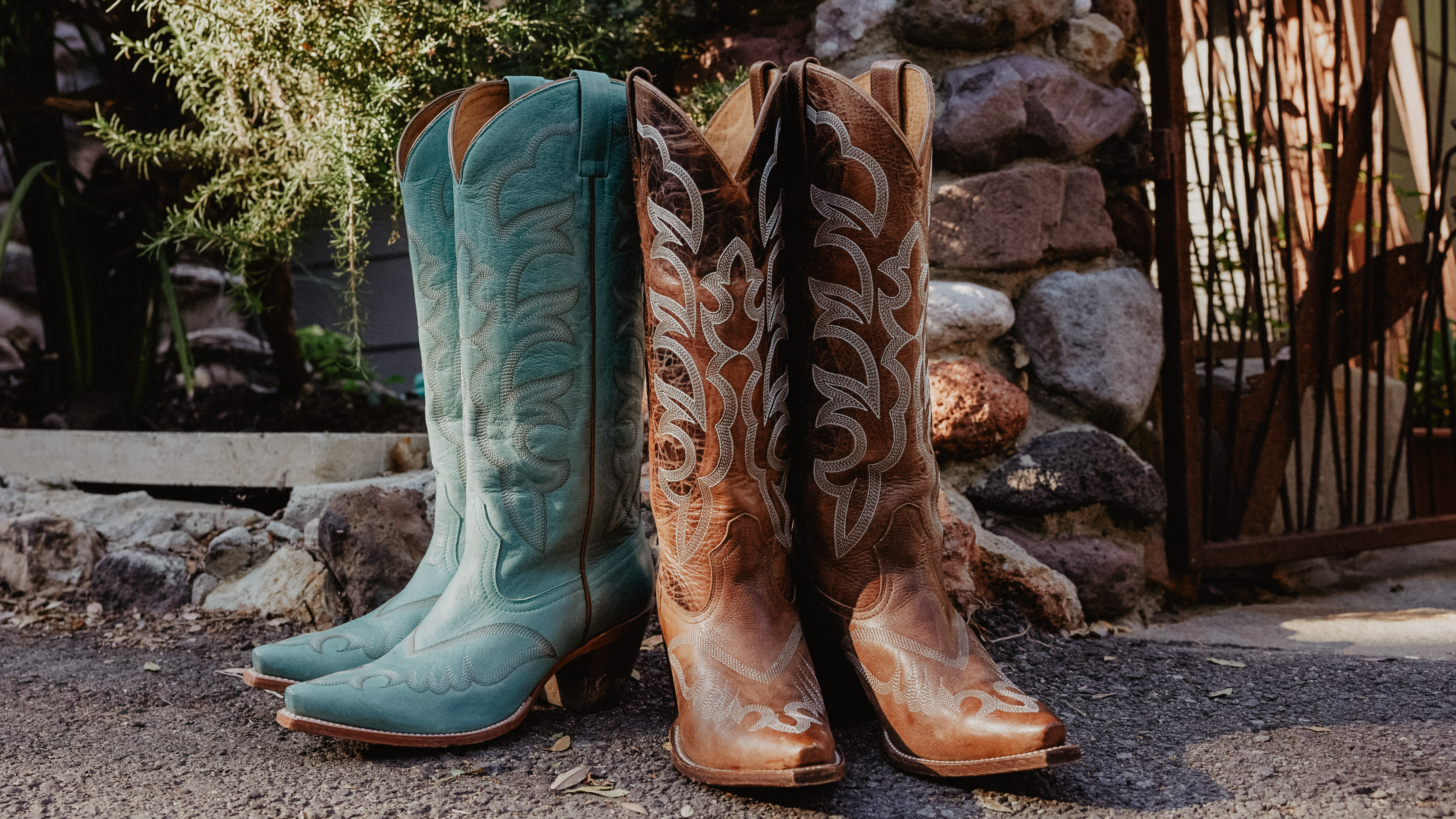 Women white boot and teal boot on ground