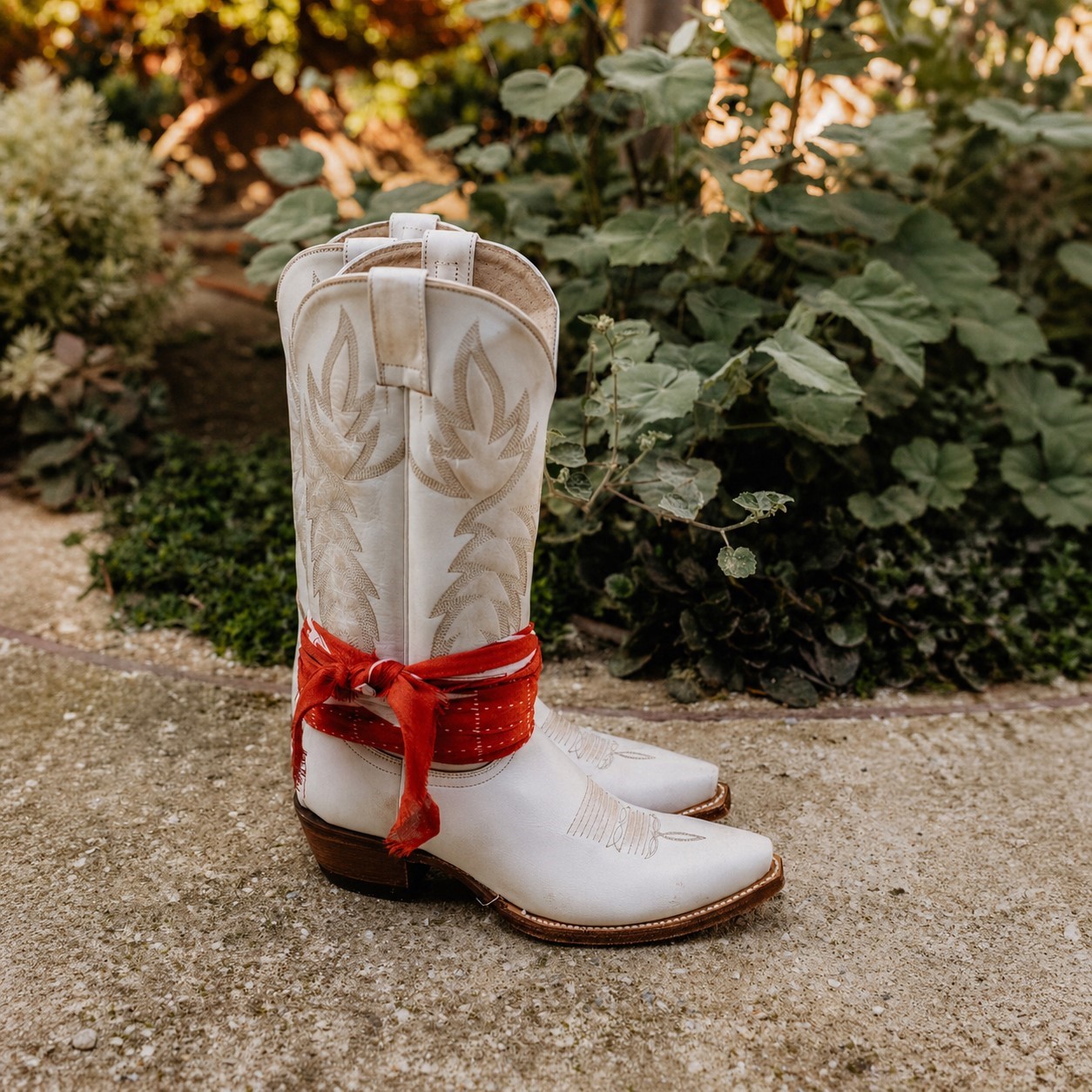 Women white boot with red bandana.