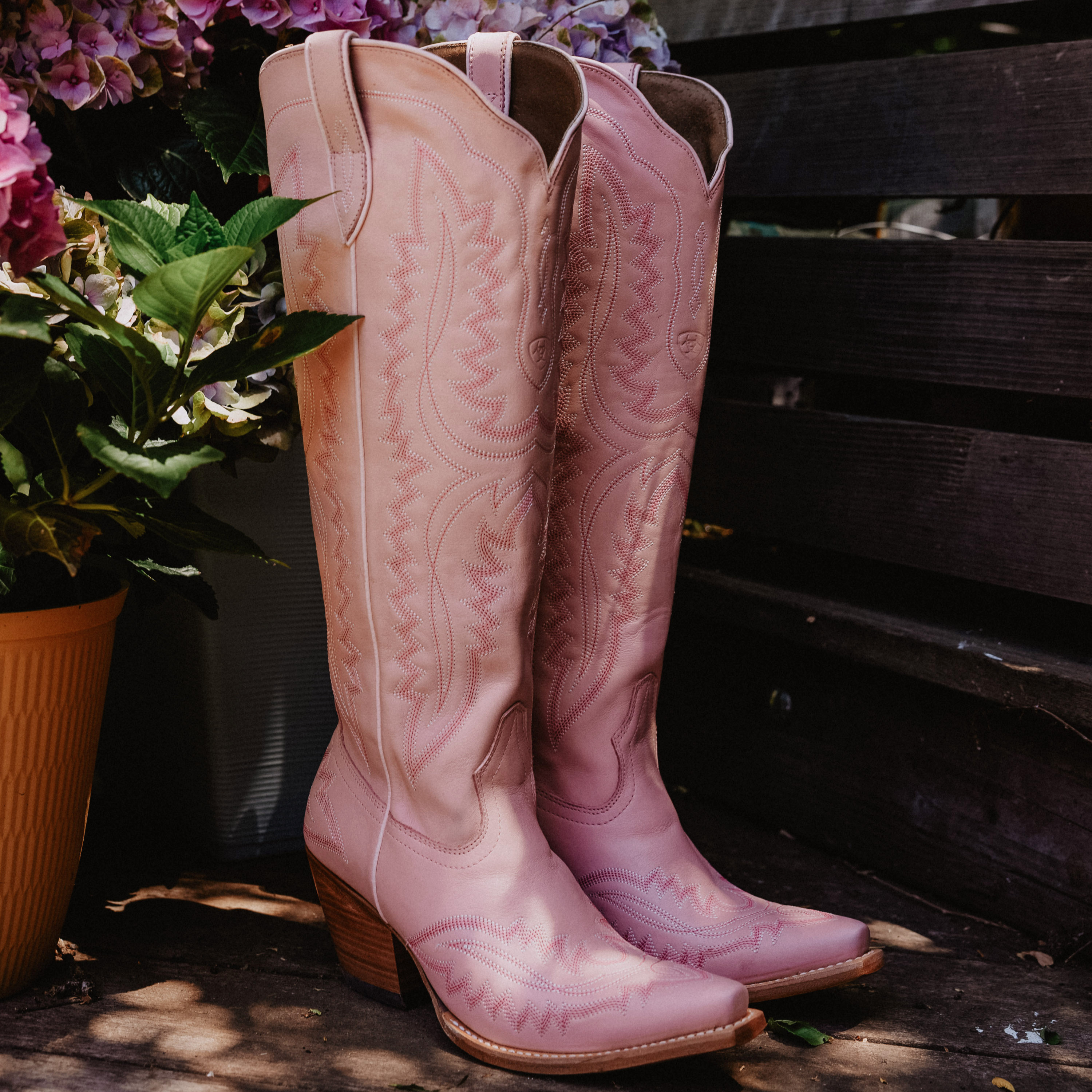 woman pink boot with floral background